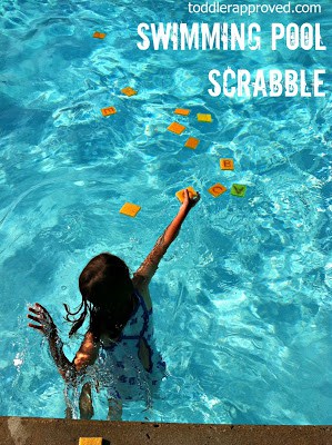 child throwing sponges into a pool