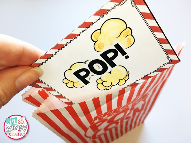 a hand pulling a car with an illustration of popcorn and the word pop! out of a red and white striped bag
