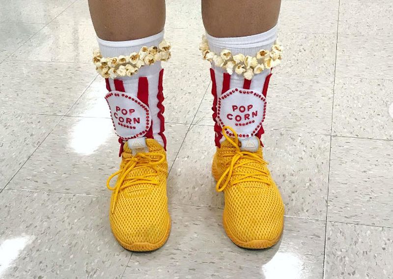 Socks that look like popcorn containers with popcorn pieces glued around the bands