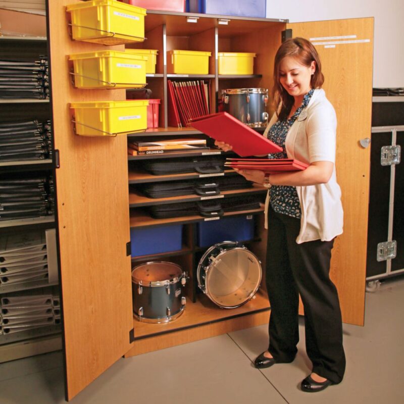 Music teacher taking music education products out of Poster-Teaching Storage Cabinet