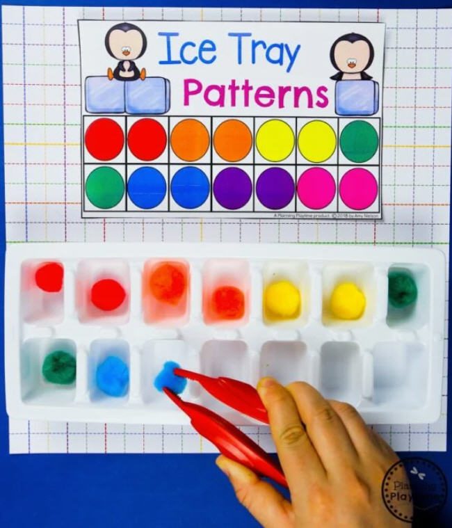 Student using tweezers to put pom poms into an ice tray to match a pattern card