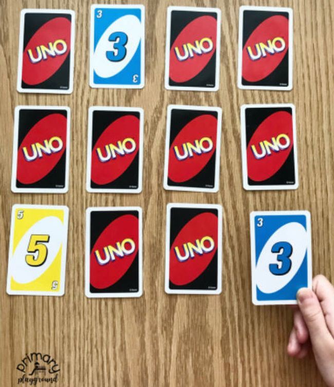 Uno cards laid out face down. with a few flipped to show their numbers