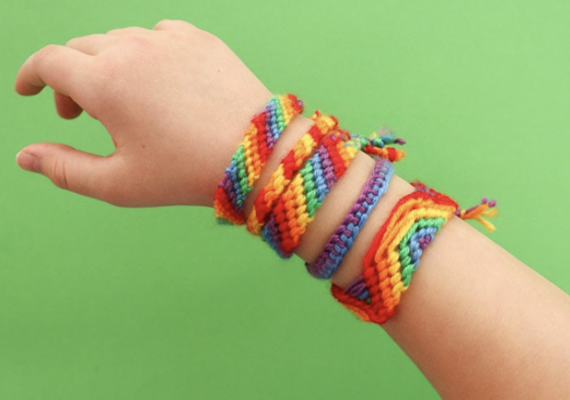 Hand with rainbow bracelets on it