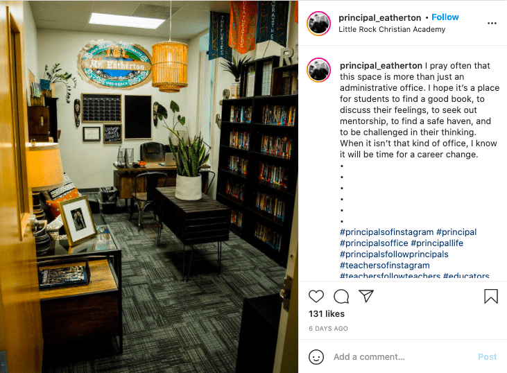 a principal's office featuring bookcases, a sofa and coffee table and a desk in the background