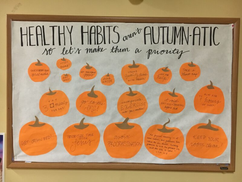 A simple bulletin board says "healthy habits aren't autumn matic." It has different sized pumpkins with healthy habits written on them.