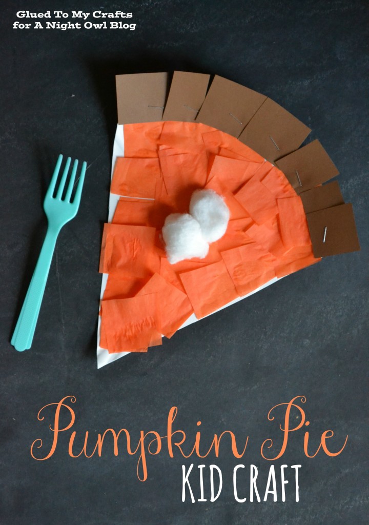 A blue plastic fork lays beside a crafted piece of pie made from tissue paper and cotton balls.