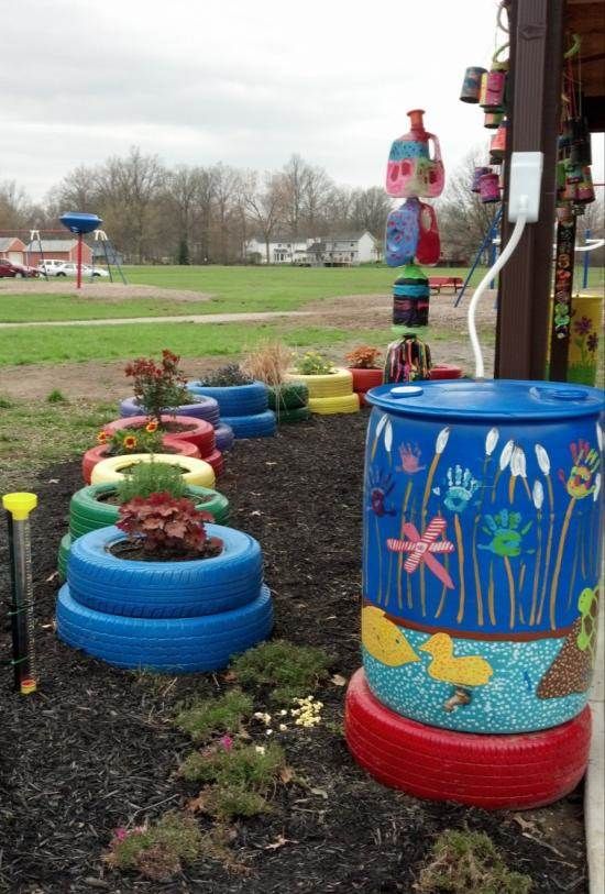 painted rain barrel and colorful tires outside an elementary school 