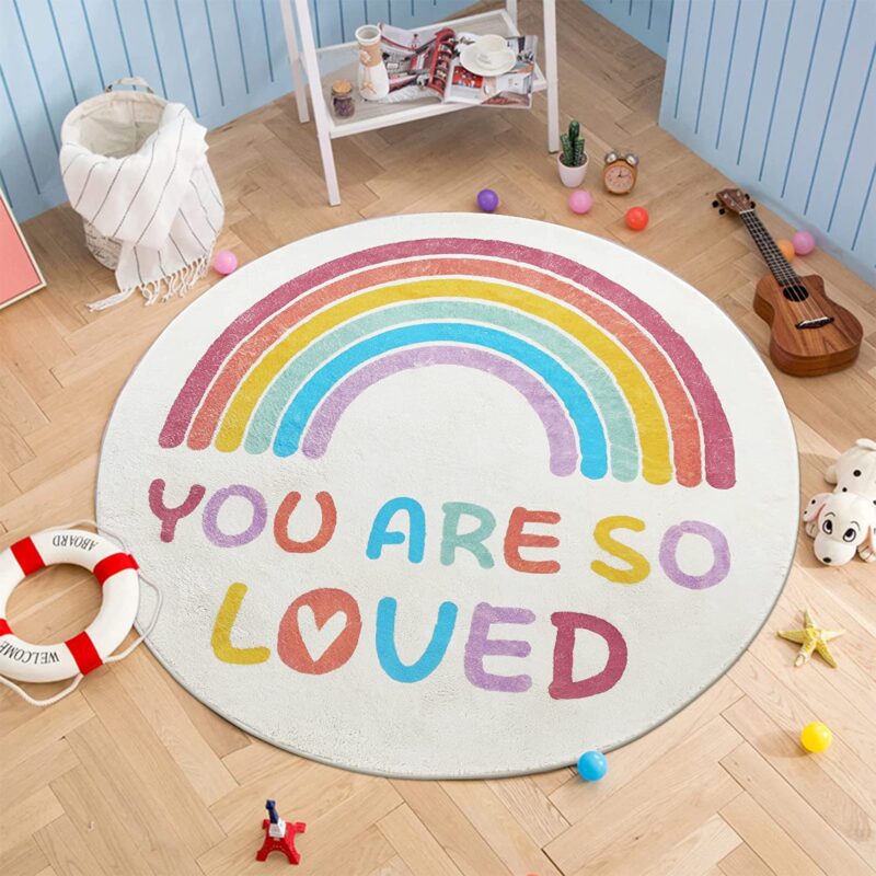 Classroom rugs can be round like this one that features a rainbow and the message You are So Loved.
