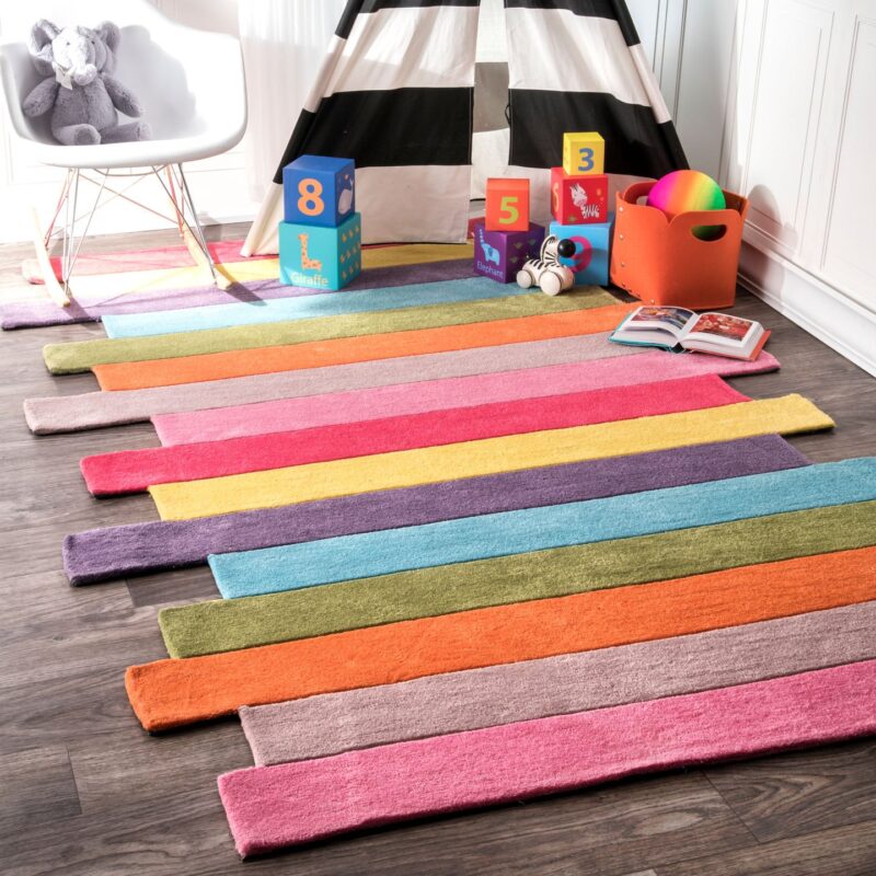 Classroom rugs can be colorful like this rug made up of different colored stripes. The edges are jagged.