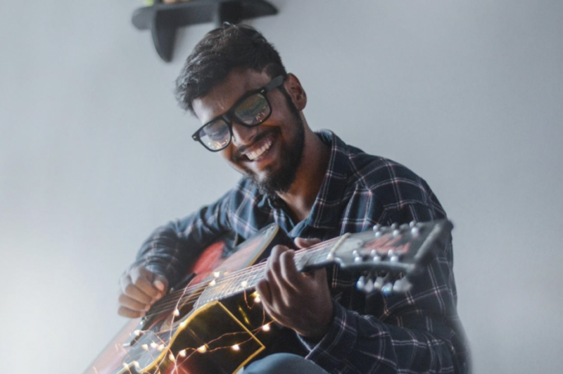 Man strumming guitar