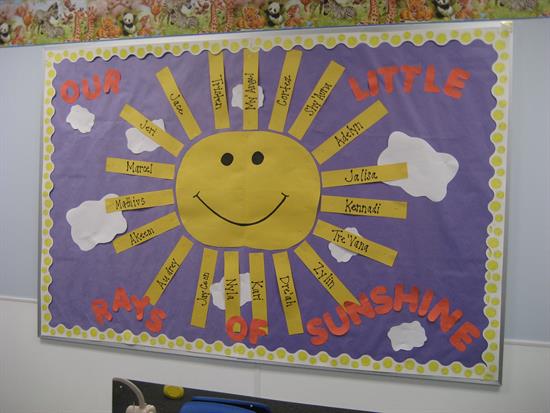 A bulletin board says our little rays of sunshine. It has a sun in the middle and the rays coming out from it have names on it. 