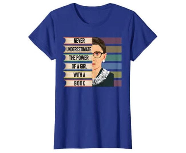 Blue t-shirt with picture of Ruth Bader Ginsburg saying Never Underestimate The Power of a Girl With a Book