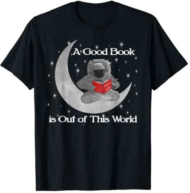 Black t-shirt with picture of astronaut sitting on a crescent moon with a book, text reads A good book is out of this world (Reading Shirts)