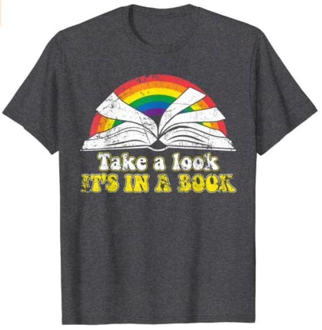 T-shirt with open book in front of a rainbow, and text Take a look, It's in a book (Reading Books)