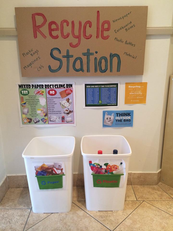 recycle station with bins and posters for a green school idea