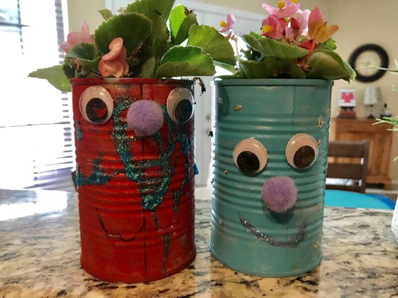 tin cans painted and made into flower pots for green school idea