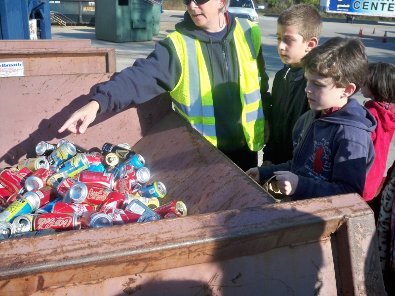 students looking at cans at the recycling center 