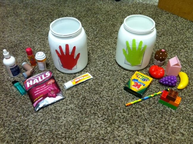 Two jars with red and green handprints, with items like cough drops and crayons