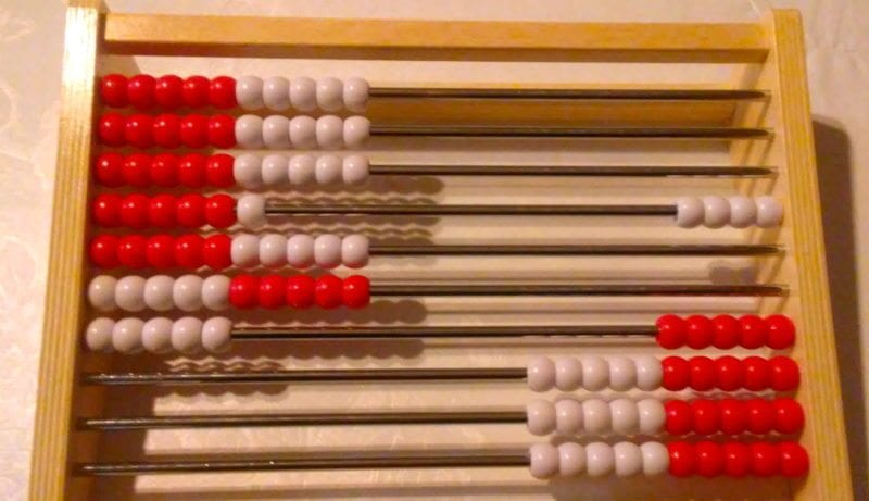 A rekenrek- a wooden frame with parallel dowels threaded with red and white beads