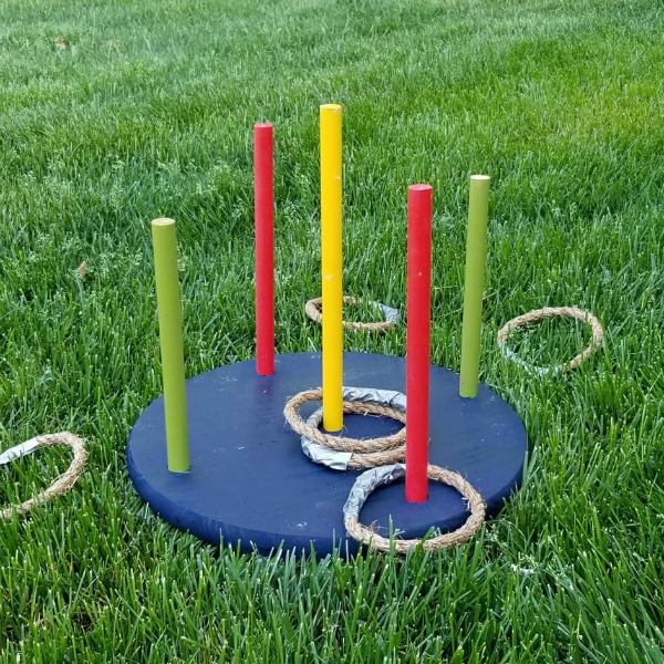Ring toss game set up in the grass.