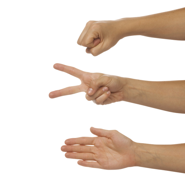 Three hands against a white background, each hand showing a different choice in a game or rock, paper, scissors