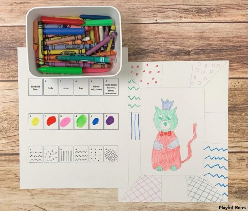 Drawing games like this one use dice. A box of crayons sits beside a chart showing which side of the dice equate to what color and character. A drawing of a cat as a prince is beside it.