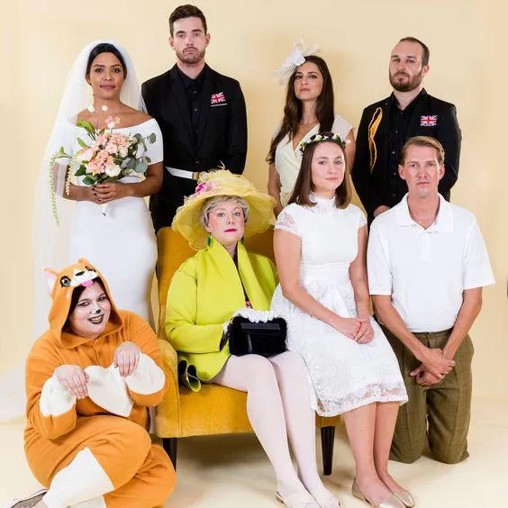 Eight people are dressed as different members of the Royal Family including one who is a dog.