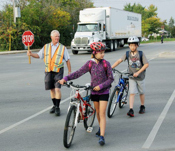 Children on bikes crossing at the cross walk 