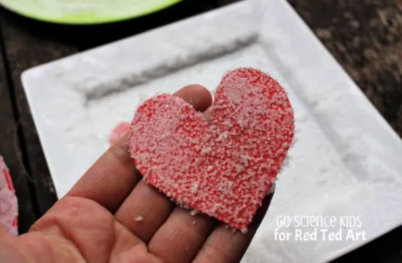 Red construction paper heart covered in salt crystals from a science experiment
