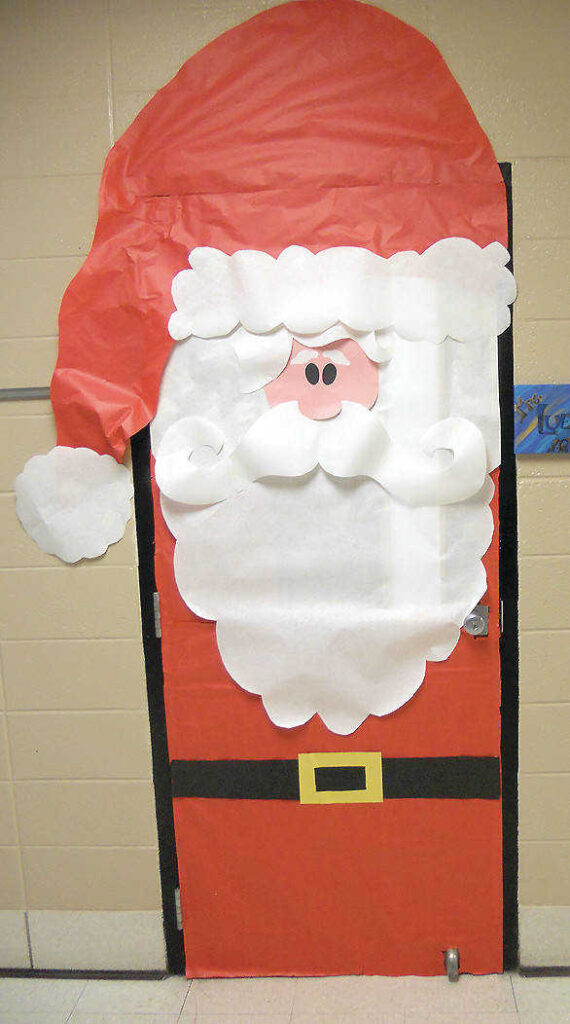 Holiday classroom doors include this one that is decorated to look like Santa Clause.