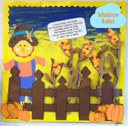 October bulletin board ideas include this one with a scarecrow behind a fence with pumpkins and corn stalks. Text shows lyrics to "if I only had a brain" changed to "if I only had a book." 