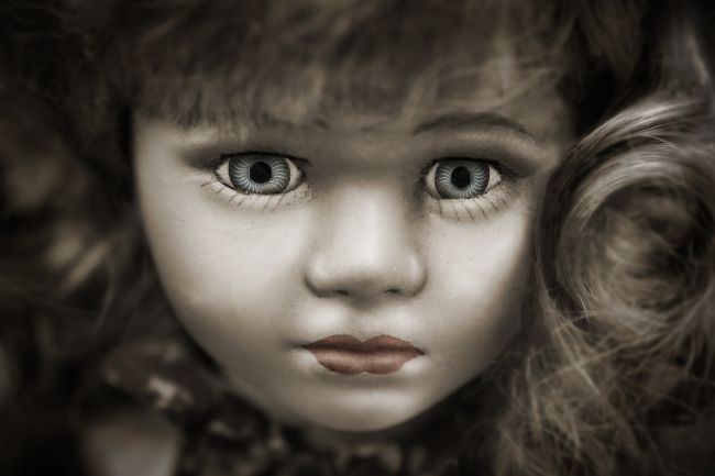 Closeup of a porcelain doll's face in sepia tones