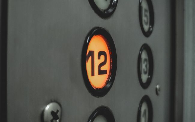 Elevator buttons, with the number 12 lit up