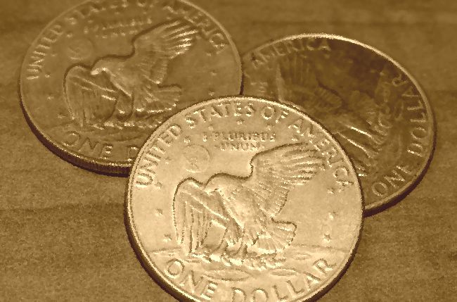 Three American silver dollar coins, pictured in sepia tones