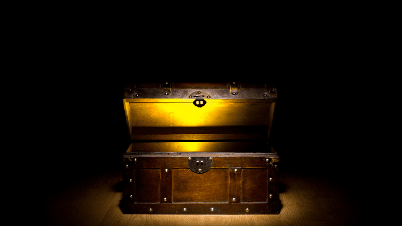 Treasure chest with something gold glowing inside