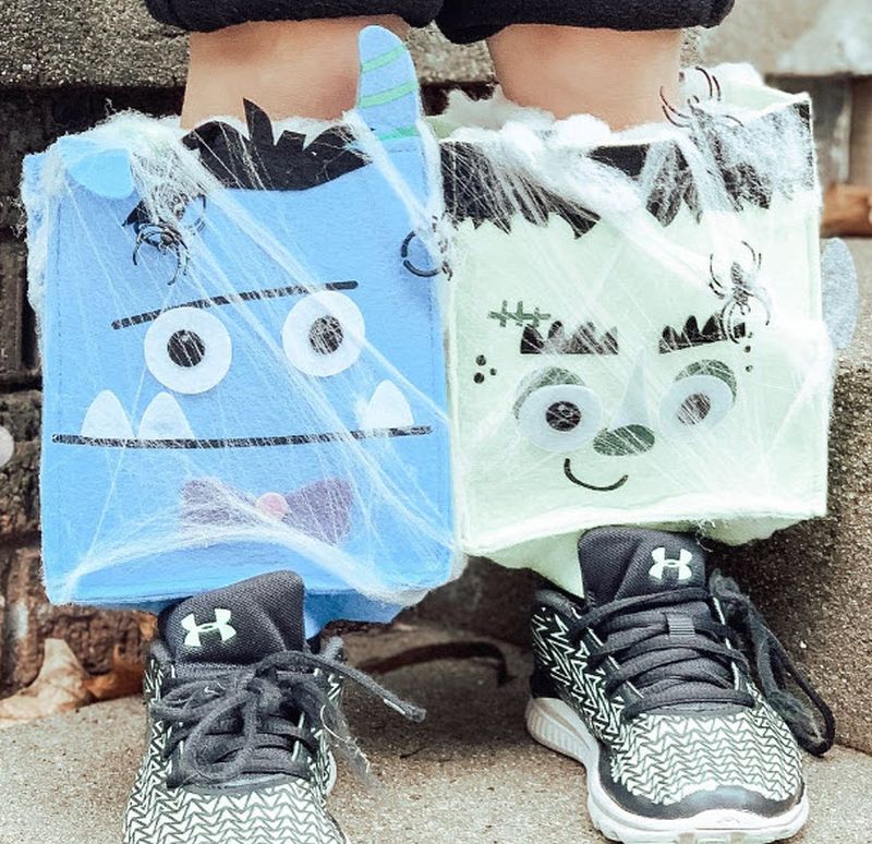 Socks covered in paper monster heads with fake spider webs