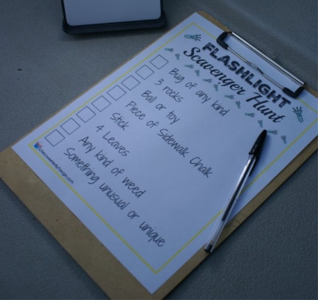 A simple scavenger hunt printable on a clipboard, with a pen and a flashlight