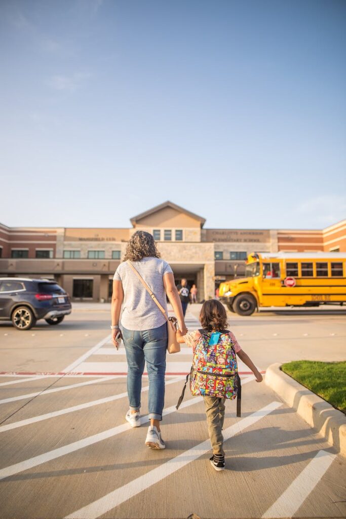 photo-of-parent-and-child-walking-to-school-building-title-1