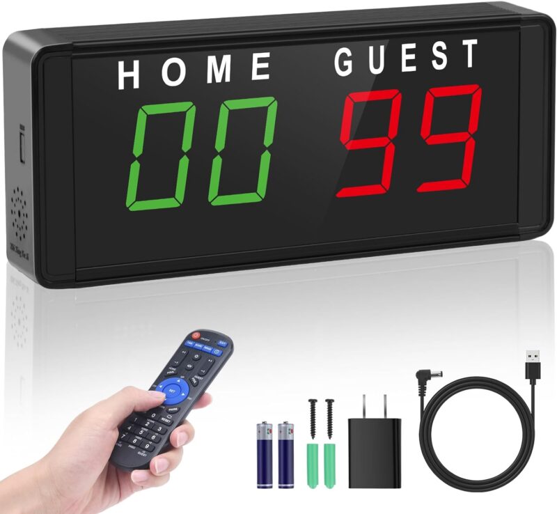 Portable electronic scoreboard with hand holding remote.