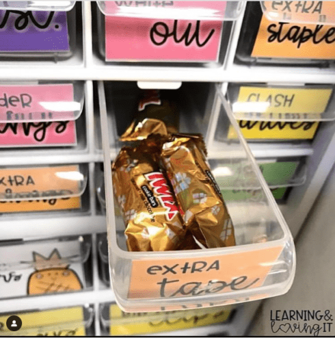 Instagram-worthy teacher hacks include little organizers like this one that shows a drawer pulled out with mini twix candy bars in it.
