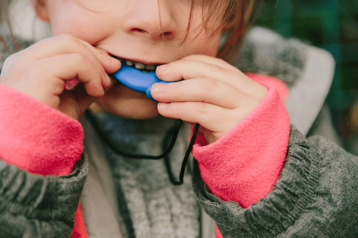Child eating a sensory chew necklace