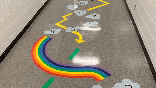 Path on the floor made of cloud-shaped stones and a rainbow arch, as an example of sensory room ideas