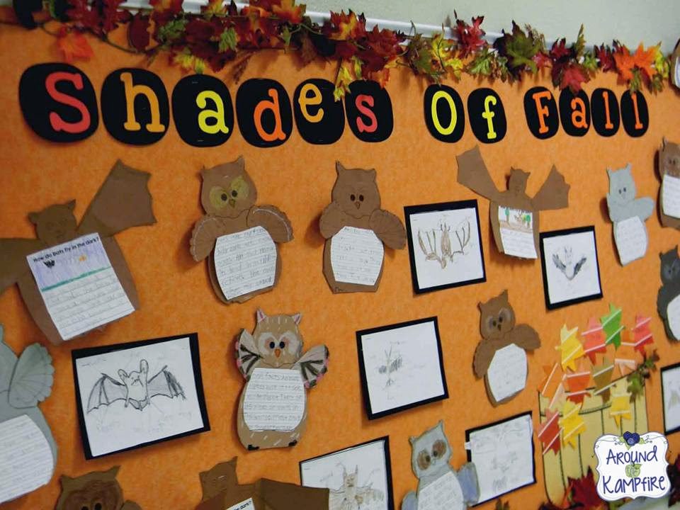 Shades of fall are in orange, red, and yellow lettering across the top of the September bulletin board. Bats and owls hold drawings and writing papers that have been completed by students.