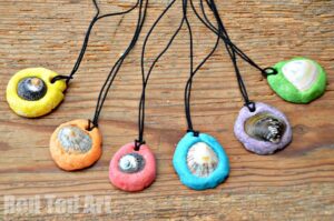 Colorful pendants made from shells pressed into modeling clay