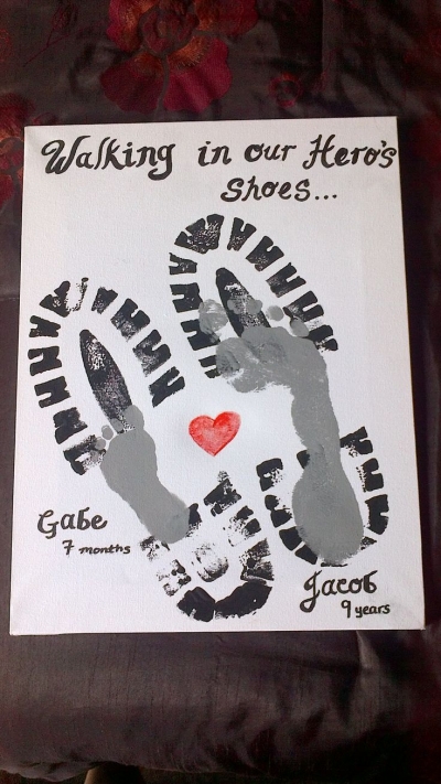 The best Father's Day crafts for kids that include footprints and handprints like this one are popular. Men's size shoe prints are overlayed with a child's footprint.