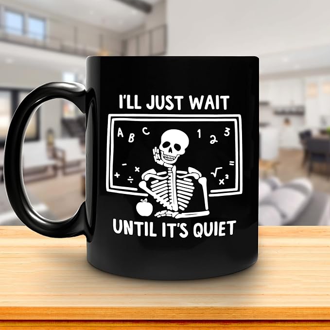 Black mug with skeleton illustration that says I'll just wait until it's quiet.- Halloween gifts for teachers