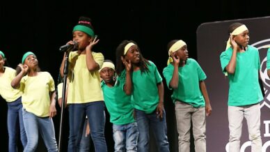 A group of black students performing at a poetry slam