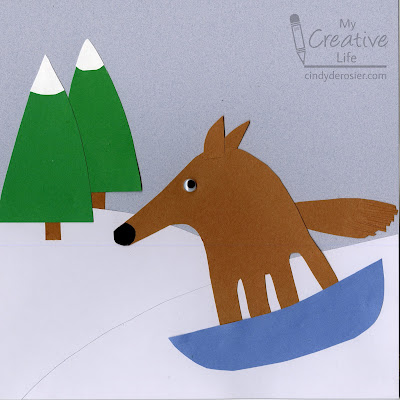  A winter scene made from construction paper featuring a handprint-traced dog