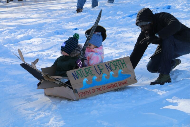 sledding using a cardboard box for a fun winter activity