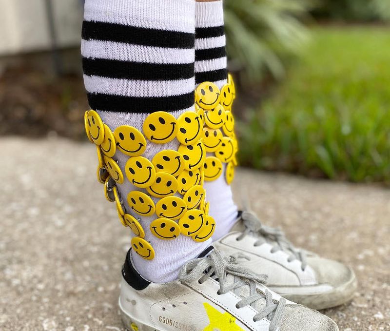 Black and white striped socks decorated with mini smiley face buttons